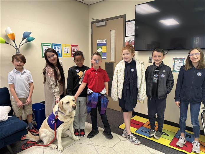  Students at CTA Humphrey spend time with therapy dog Hank from Gabriel's Angels in February 2023.