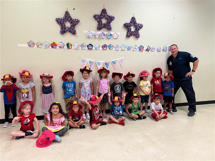 An image of a community first responder with Andersen Elementary students.