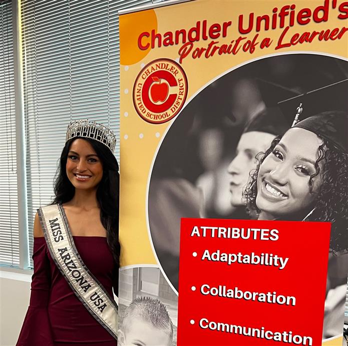  Isabel Ticlo stands next to a Chandler Unified School District Portrait of a Learner sign