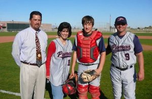From left: Principal Dan Serrano, Superintendent Camille Casteel, catcher Alex Burridge, and head coach Shane Hilstrom celebrate Perry's first game in 2008.