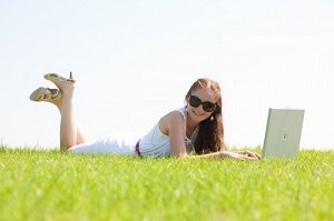 Girl on laptop in field