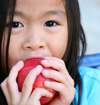 Girl eating an apple.