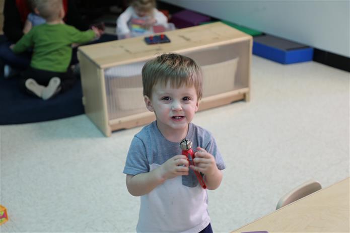  Image of young student holding a jingle bell
