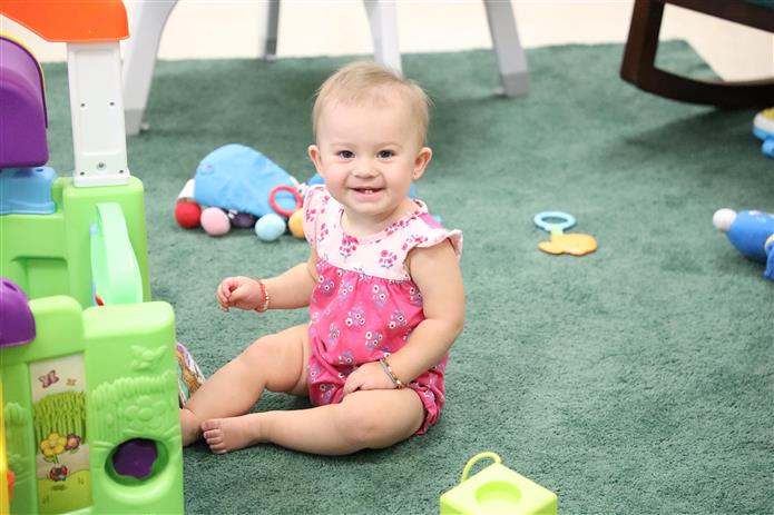  Image of infant looking at the camera and smiling 