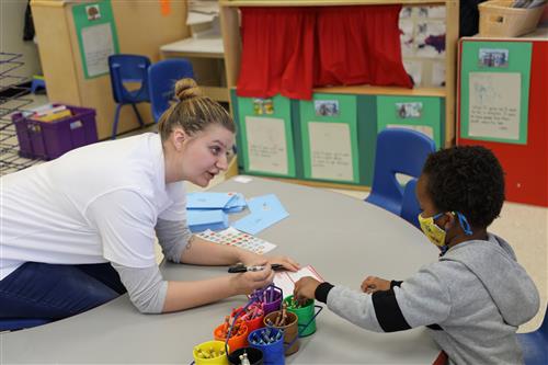 Picture of Elizabeth Scott writing something down for a child