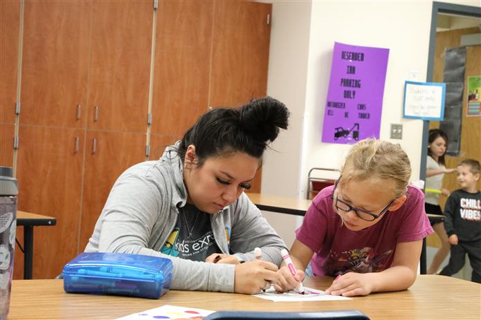  Image of Isabel Phelps coloring with a child