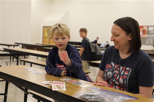 Image of Kathy Turner playing cards with a little boy