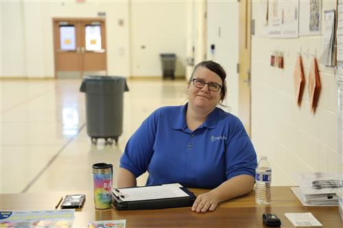 Picture of Michelle Scott smiling at the Kids Express check in table