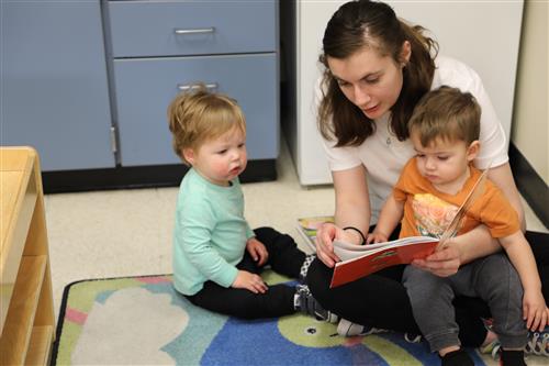 Picture of Rebecca Scott reading to two children