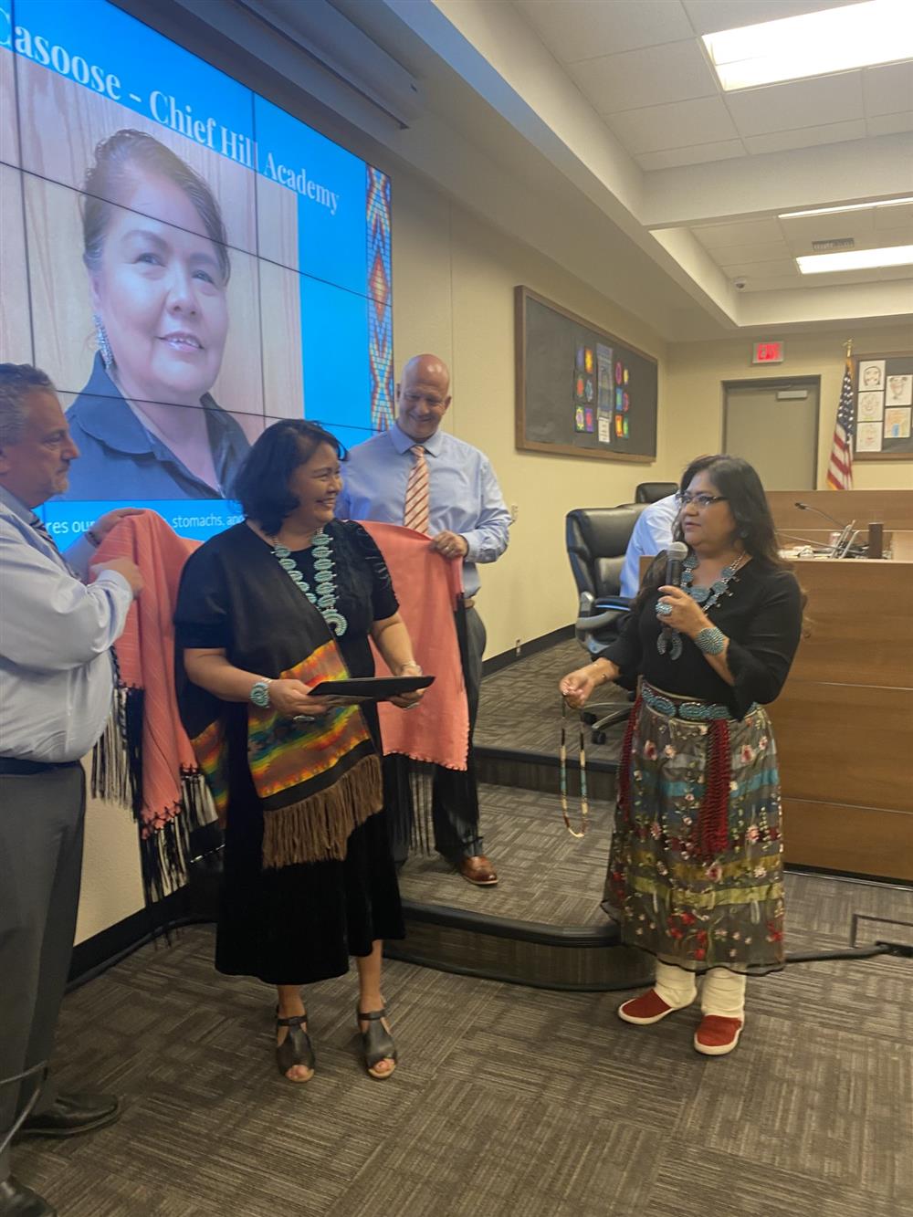 Mrs. Casoose receiving her award
