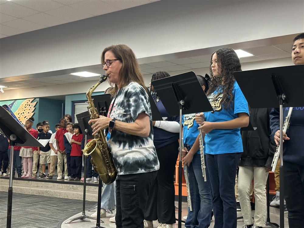 An image of Frye's band teacher playing the national anthem.