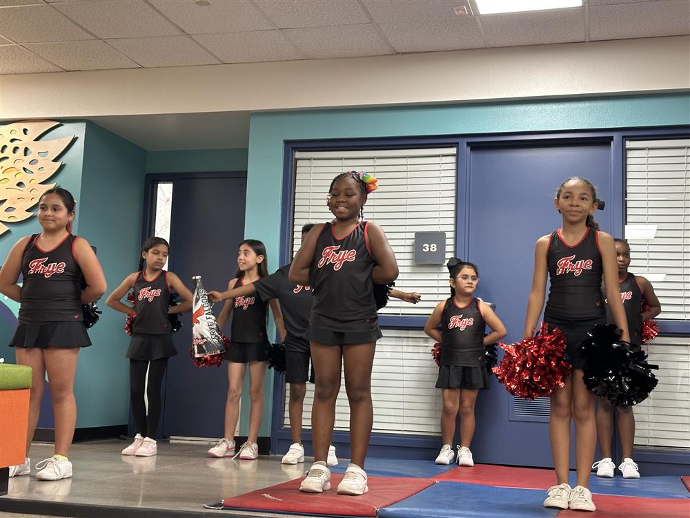 An image of Frye Elementary cheerleaders preparing to perform.