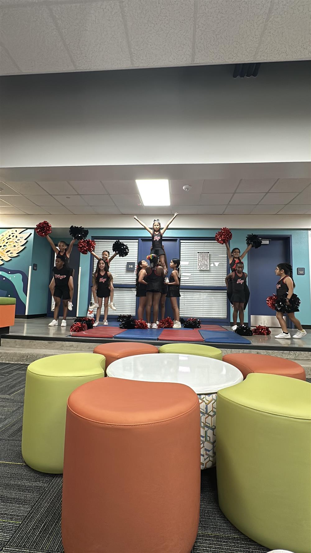 An image of Frye Elementary's cheerleaders stunting during their performance.