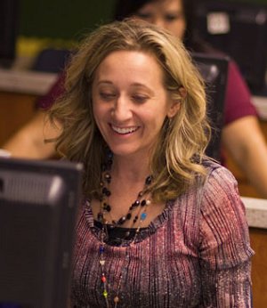Teacher smiling at computer